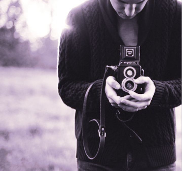 someone holding a camera with black and white filter